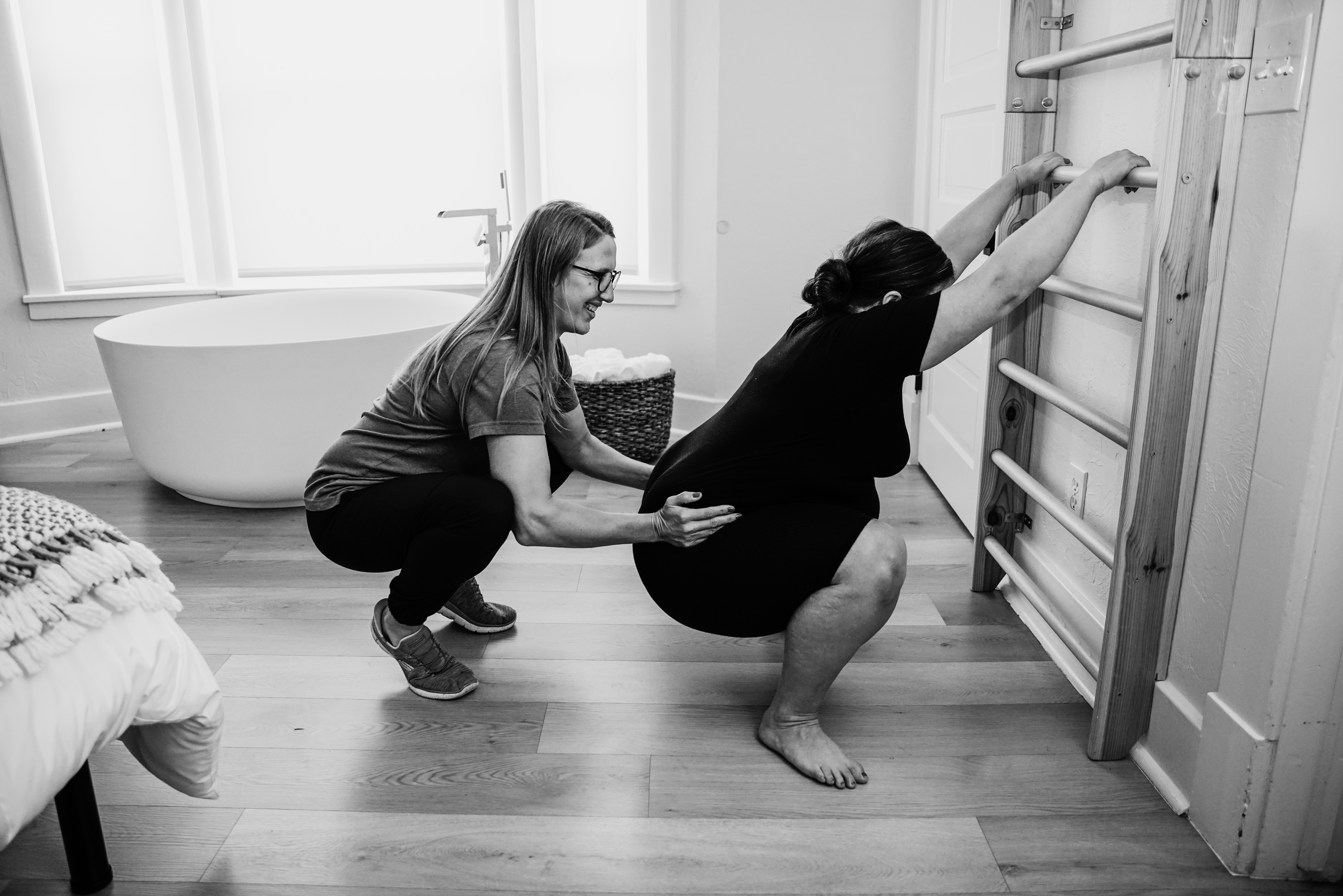 Birth doula comforting a pregnant woman during active labor